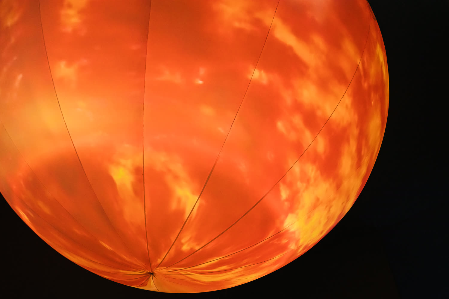 The sphere as a burning sun, orange and mottled.